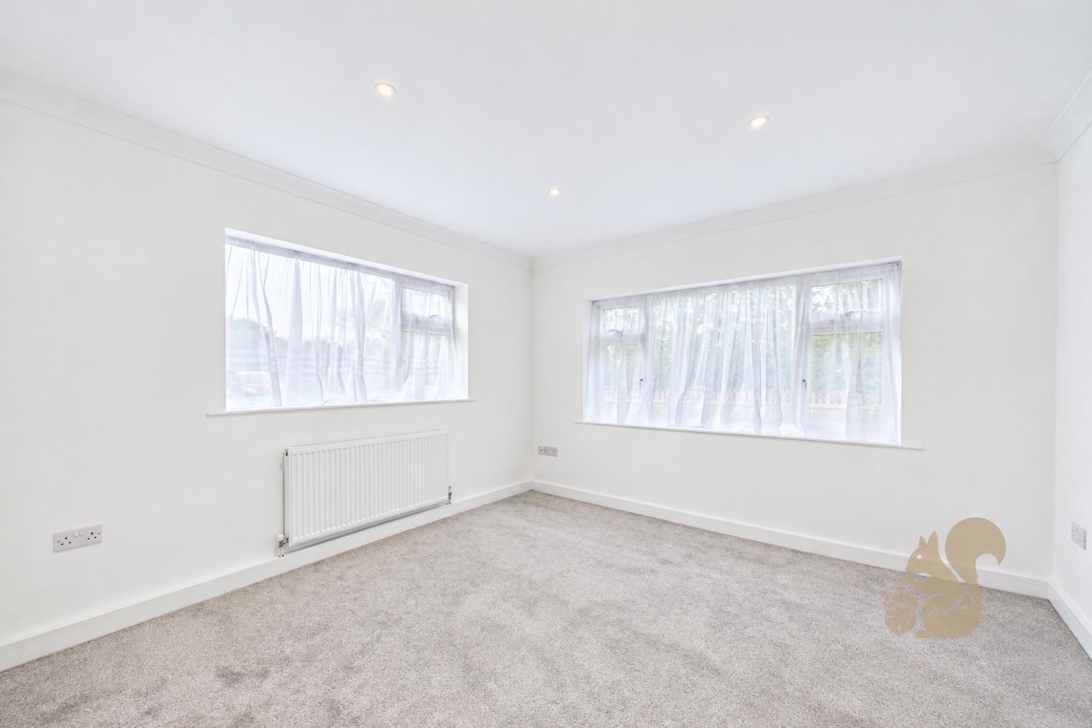 Bright Empty Room with Sheer Curtains.png